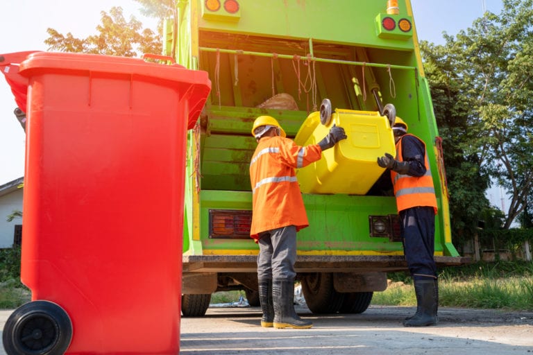 Image of two refuse waste people emptying a bin into a bin truck and a red bin in the for ground. EQTEC are marketing leaders in the gasification industry. Click to find out more.