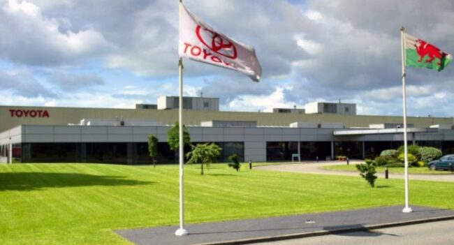 Toyota HQ image with flag flying with Toyota logo on.